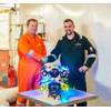 Alexander Bahr, Hydromea COO, and Keiran Hope, ACE COO, shake hands on service partnership with EXRAY wireless ROV in the center. Image courtesy Hydromea