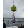 Figure 1.  Schmidt Ocean Institute benthic lander is deployed from R/V Falkor for an operational test.  Syntactic flotation high, integrated acoustic release low, and the expendable anchor weight suspended below the platform deck.  The negative weight of the release is placed close to centerline for trim, and positioned low to act as a counterweight for stability.  No instruments are mounted on the white marine grade HDPE frame. The anchor weight is rigged for recovery after the test.  (Photo by