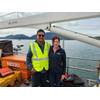 Pictured from left to right: Adrian Maharaj (Pioneer Consulting's shipboard representative) and Sarah Kathrein (CTC Project Manager) aboard the marine route survey vessel for the FISH West and FISH South submarine cable systems at the start of the survey in May 2025. © Cordova Telecom Cooperative, Inc.