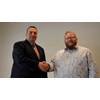 Sonardyne’s Andrew Wood (left) and NDI’s Andy Meecham (right) conclude the deal that sees NDI become Sonardyne’s nonexclusive partner for maritime security in the U.S.