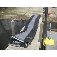 A 25-foot section of inland underwater oil barrier is laid out on a dock prior to deployment, Monday, April 23, 2018, in Kalamazoo, Mich. The three-foot high barrier is made of PVC and X-Tex fabric, and is designed to let water flow through while trapping oil. Weighted chains and scour flaps prevent oil and sediment from flowing underneath the barrier. (U.S. Coast Guard Photo courtesy of Research and Development Center)