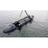 Chloe Mallet (right), an ocean engineer at HII’s Undersea Solutions Group (USG) subsidiary, prepares to crew and drive the Proteus dual-mode underwater vehicle with USG Vice President Ross Lindman (left). Mallet and Andrea Raff (not pictured), a mechanical engineer at USG, are the first women to crew and drive a swimmer delivery vehicle. (Photo: Joe Colamaria/HII)
