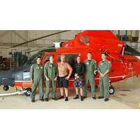 A Coast Guard Air Station Corpus Christi MH-65 Dolphin helicopter aircrew stands with two rescued divers after they were located and rescued Saturday, June 27. (U.S. Coast Guard photo)