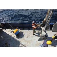 Crew aboard the Office of Naval Research (ONR)-sponsored research vessel (R/V) Melville retrieve a wave buoy during an at-sea demonstration of the Environmental & Ship Motion Forecasting (ESMF) program.