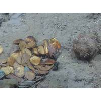 Gold coins and a gold box lie in situ on the site of another shipwreck (Black Swan) site salvaged by Odyssey Marine Exploration (Photo courtesy of Odyssey Marine Exploration)