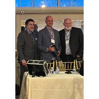  Greensea’s CEO Ben Kinnaman, center, with the "Rising Tide" award. Image courtesy Greensea