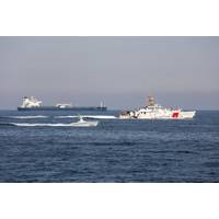 An L3Harris Arabian Fox MAST-13 unmanned surface vessel transits the Strait of Hormuz accompanied by USCGC Charles Moulthrope (WPC 1141) and USCGC John Scheuerman (WPC 1146) on April 19, 2023. (Photo: Vincent Aguirre / U.S. Coast Guard)
