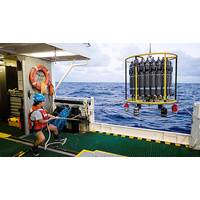 A marine technician hauls in the CTD (conductivity, temperature, and depth) rosette on a research cruise in the Sargasso Sea. © Maya Thompson
