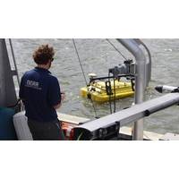 NOAA scientist operates an autonomous surface vehicle in the Port of Gulfport, Miss., during the Commander, Naval Meteorology and Oceanography Command’s Advanced Naval Technology Exercise on Nov. 6, 2019, to test and evaluate new maritime technologies. (CNMOC)