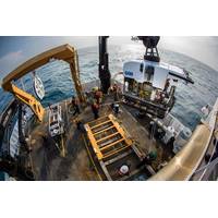 Okeanos Explorer's dual-body ROV system is loaded from the aftdeck of the ship into the water before conducting an exploration dive. (Credit: NOAA)