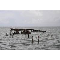 To promote ecological restoration of Horn Island, the National Park Service, with support from the NOAA Marine Debris Program (MDP), spearheaded a large collaborative effort to assess and remove this sunken barge. (Credit: NOAA).
