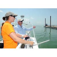 Rearchers point towards barge: Photo courtesy of Island Univ.
