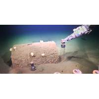 Researchers use Remotely Operated Vehicle SuBastian to collect sediment push cores next to barrels discarded on the seafloor. Credit: Schmidt Ocean Institute.