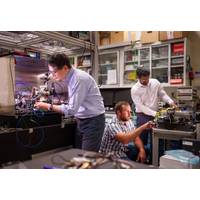 Sandia National Laboratories scientist Jongmin Lee, left, prepares a rubidium cold-atom cell for an atom interferometry experiment while scientists Ashok Kodigala, right, and Michael Gehl initialize the controls for a packaged single-sideband modulator chip. (Photo by Craig Fritz)