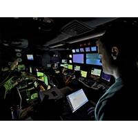 Scientists direct a remotely operated vehicle deep in the ocean from the mission control room aboard NOAA Ship Okeanos Explorer. (NOAA Okeanos Explorer team, INDEX-SATAL expedition)