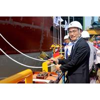 Takaaki Anraku, President Kokusai Cable Ship Company Ltd of Japan, cutting the rope to break the milk pot against the vessel’s hull. Photo: Colombo Dockyard PLC