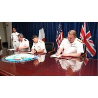 Vice Adm. Louis-Michel Guillaume, left, commander of French Submarine and Strategic Oceanic Forces, Vice Adm. Kevin M. Donegan, middle, commander of the U.S. Naval Forces Central Command, and Rear Adm. Robert K. Tarrant, commander Operations of the Royal Navy, sign an agreement to increase coordination for anti-submarine warfare activities between France, the U.S. and the United Kingdom. Photo: United States Navy