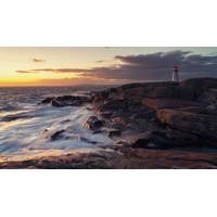 Waves wash against Nova Scotia's Atlantic coast at Peggy's Cove Lighthouse. © Carbon to Sea