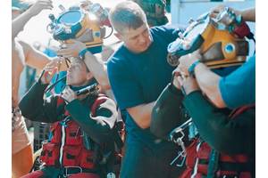 Commander Bobbie Scholley and Captain Chris Murray in Mk 21 with DUI hot water suits in preparations to dive to 240 fsw during MONITOR Expedition 2001. Photo courtesy of US Navy/Released.