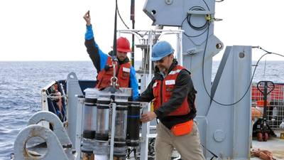 Marine chemist Ken Buesseler (right) deploys a sediment trap during a 2018 expedition in the Gulf of Alaska. © Alyson Santoro, Woods Hole Oceanographic Institution