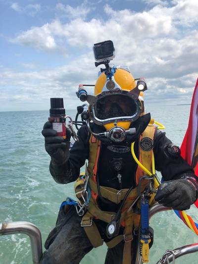 An MSDS Marine diver prepares to dive holding a Nano transponder. - Credit: Sonardyne