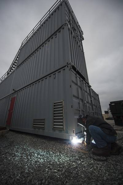 Nick Lugue Jr., a welder with Naval Facilities Engineering Command Southwest, welds a new firefighting trainer into place at Naval Air Station North Island. The trainer is the first of four new trainers the Navy is building that will simulate potential fire hazards aboard submarines. (U.S. Navy photo by Mass Communication Specialist 3rd Class Todd C. Behrman)
