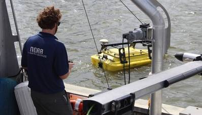 NOAA scientist operates an autonomous surface vehicle in the Port of Gulfport, Miss., during the Commander, Naval Meteorology and Oceanography Command’s Advanced Naval Technology Exercise on Nov. 6, 2019, to test and evaluate new maritime technologies. (CNMOC)