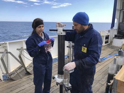 Sediment samples from the bottom of the sea come inside a transparent plastic tube. The scientists are removing the sediments from the tube using a holder to access the sediment at different depths inside the tube (pictured: Mahboubeh Rahmati Abkenar, post doc and Sina Shahabi Ghahfarokhi, Ph.D. student). © Marcelo Ketzer