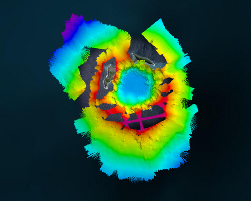 Aerial view of the Hunga-Tonga Hunga-Ha’apai (HT-HH) volcano, showing new multibeam depth data overlaid on a satellite image of the islands (deep depths in blue, shallow depths in red). Credit: SEA-KIT / NIWA-Nippon Foundation TESMaP survey team. (Image: SEA-KIT)