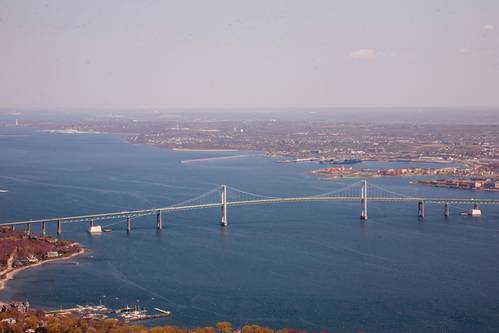 Aerial view of Narragansett Bay with the Claiborne Pell Bridge, known as the Newport Bridge, in the foreground. Naval Station Newport is to the north right of the bridge.