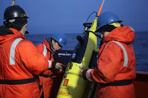 Author Lilian Dove, at right, works with oceanographer Isa Rosso and marine technician Richard Thompson to prepare an oceangoing autonomous vehicle to take measurements in the Southern Ocean. (Photo: Linnah Neidel)