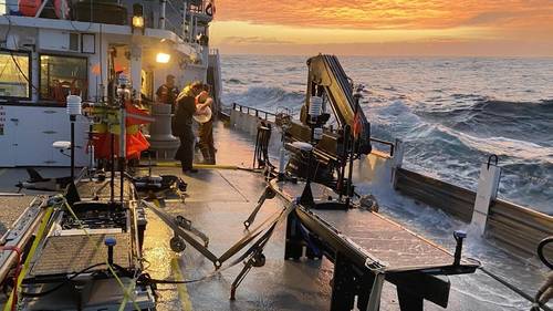 Autonomous wave gliders are seen being prepared for deployment on the deck of the research vessel Oceanus during the pilot campaign for NASA's Sub-Mesoscale Ocean Dynamics Experiment (S-MODE) in the Pacific Ocean off the U.S. West Coast. (Photo: Ben Hodges / Woods Hole Oceanographic Institution)