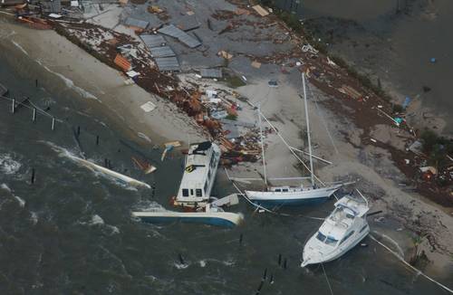 Boats are washed up on shore along the Florida coast during Hurricane Ivan in 2004. (U.S. Coast Guard photo by Stacey Pardini)