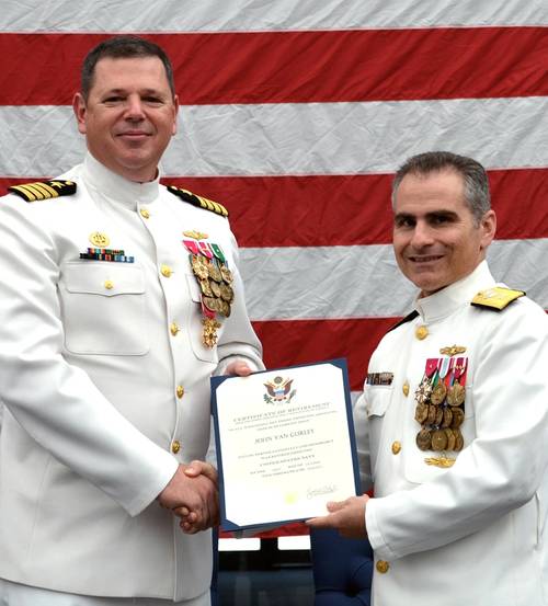 Rear Adm. Brian Brown, commander, Naval Meteorology and Oceanography Command, (right) presents Capt. Van Gurley with a certificate of retirement commemorating 26 years of naval service during a ceremony held July 12 at Stennis Space Center, Miss. (U.S. Navy photo by Jenni Ervin)