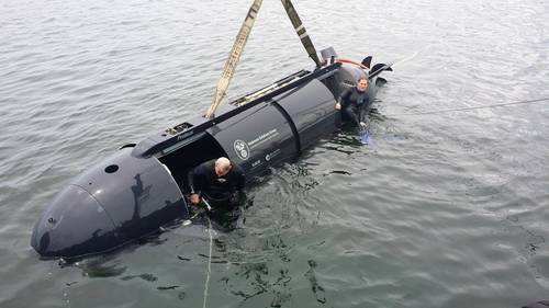 Chloe Mallet (right), an ocean engineer at HII’s Undersea Solutions Group (USG) subsidiary, prepares to crew and drive the Proteus dual-mode underwater vehicle with USG Vice President Ross Lindman (left). Mallet and Andrea Raff (not pictured), a mechanical engineer at USG, are the first women to crew and drive a swimmer delivery vehicle. (Photo: Joe Colamaria/HII)