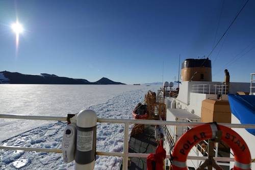 U.S. Coast Guard Cutter Polar Star, a heavy icebreaker homeported in Seattle, Washington, rests in the ice as the motor vessel Ocean Giant departs from the National Science Foundation’s McMurdo Station, Feb. 1, 2017. One of the primary responsibilities of the Polar Star’s crew is to provide an escort for the Ocean Giant through the frozen Ross Sea off of Antarctica. (U.S. Coast Guard photo by Chief Petty Officer David Mosley)