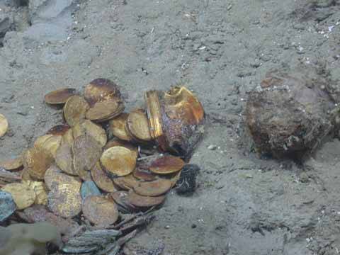 Gold coins and a gold box lie in situ on the site of another shipwreck (Black Swan) site salvaged by Odyssey Marine Exploration (Photo courtesy of Odyssey Marine Exploration)