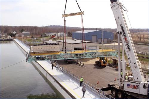 A crane replaces a bridge over the Ohmsett Oil Spill Response & Renewable Energy Test facility during refurbishment in spring 2022. (Photo: BSEE)