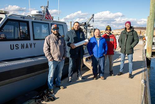 A NUWC Division Newport team assists Bionet Sonar by underwater testing its new wireless technology called HydroNet. From left: Dillon Fournier, manager, Division Newport’s Narragansett Bay Test Facility; Emrecan Demirors, co-founder of Bionet Sonar; Dr. Steve Bordonaro, director, Northeast Tech Bridge; and Bionet Sonar employees, Ryan Burke and Kerem Enhos. (Photo: Dave Stoehr / Navy)