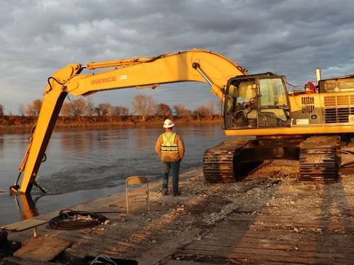 A dredging planning optimization model algorithm, developed by a data science team from the University of Houston and Rutgers weighs potential cost offsets when materials, such as sand, can be collected and repurposed. In this 2020 dredging, special equipment attached to the backhoe on the barge work boat redirected sand away from navigable areas. (Photo: U.S. Army Corps of Engineers)