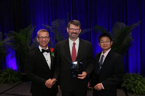 Gilles Lambaré, CGG, (center) and Sheng Xu, Statoil, (right) being jointly presented with the SEG Reginald Fessenden Award by SEG President, John Bradford (left). (Image: SEG)