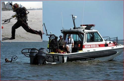 Indian River Fire Rescue diver surfaces holding 16 inch coil after recovering evidence. Inset photo: Randive diver jumps in with Pulse 8X metal detector.