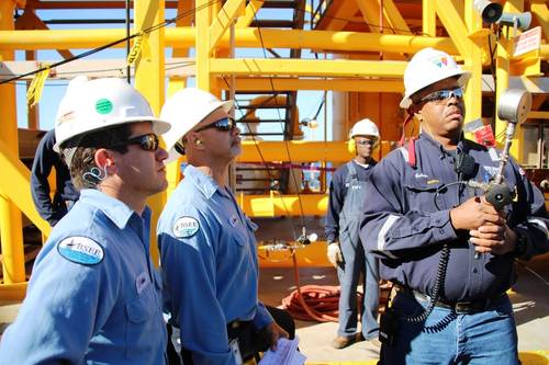 BSEE inspectors monitor a pressure gauge held by an oil worker during a pressure test of temporary equipment on a deepwater facility in the Gulf of Mexico (Photo: BSEE)