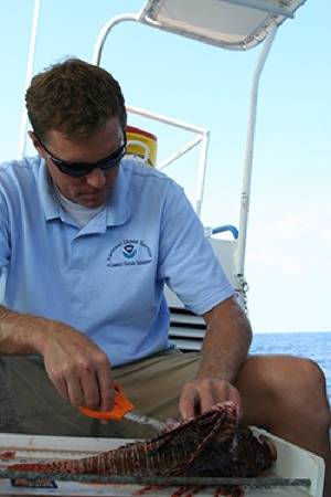 Dr. James Morris & Lionfish: Photo credit NOAA