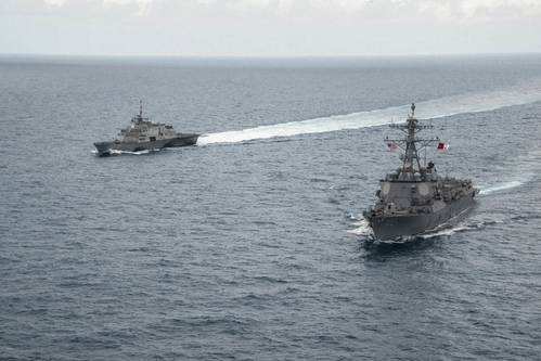 Littoral combat ship USS Fort Worth, guided missile destroyer USS Sampson and MH-60R Seahawk from Helicopter Maritime Strike Squadron (HSM) 35 operate together in the Java Sea while supporting the Indonesian-led search effort for AirAsia flight QZ8501. (U.S. Navy photo Brett Cote)