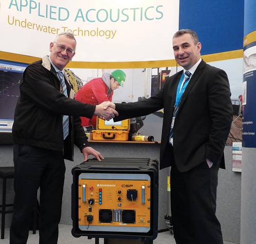 Tom Nicols of Geomatrix left, receiving his new seismic power supply, from Applied Acoustics’ Gavin Willoughby.