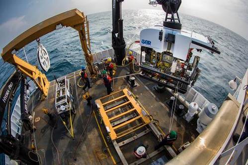 Okeanos Explorer's dual-body ROV system is loaded from the aftdeck of the ship into the water before conducting an exploration dive. (Credit: NOAA)