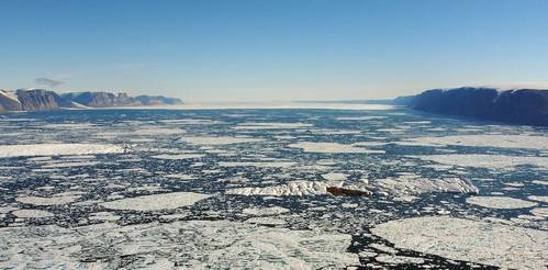 The 10km wide Petermann Fjord in northern Greenland. The author’s icebreaker ship is a small dot in the middle. The cliffs on either side are a kilometer high. In the distance is the ‘ice tongue’ of the glacier flowing into the fjord. Martin Jakobsson, CC BY-SA