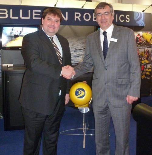 Omer Poroy (Bluefin Robotics) and Nick Swift (Sonardyne) on stand with Bluefin Robotics' AUV at Oceanology International.