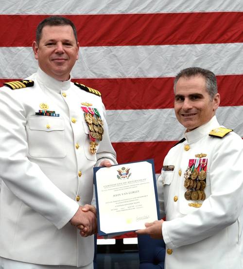 Rear Adm. Brian Brown, commander, Naval Meteorology and Oceanography Command, (right) presents  Capt. Van Gurley with a certificate of retirement commemorating 26 years of naval service during a ceremony held July 12 at Stennis Space Center, Miss.  (U.S. Navy photo by Jenni Ervin)
